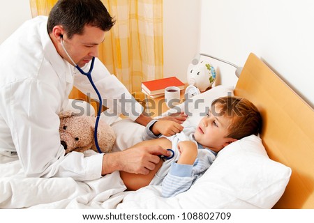a physician house call. examines sick child.