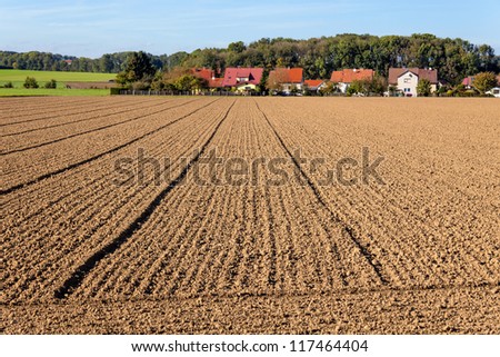 the freshly tilled fields of the farmers. background urbanization. spatial planning and regional planning.