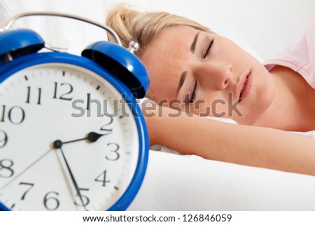 insomnia with clock in the night. woman can not sleep.