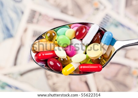 Tablets and Japanese Yen currency symbol for health costs