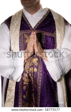 a Catholic priest in prayer in worship