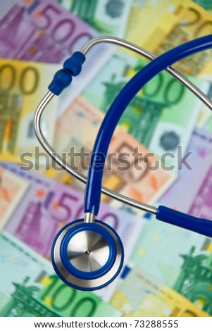 Many Euro bank notes with a stethoscope. Health costs.