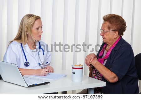 an elderly lady at the doctor in practice. consultation with the doctor.