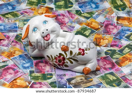 a funny piggy bank is in swiss francs