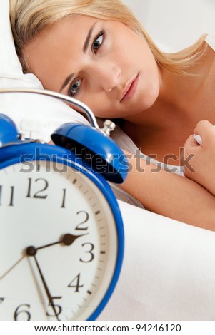 clock with sleep at night. woman can not sleep.