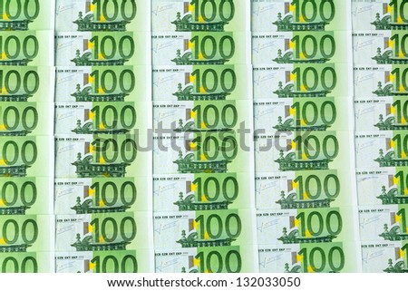many einhhundert euro banknotes lie side by side. symbolic photo for wealth and investment