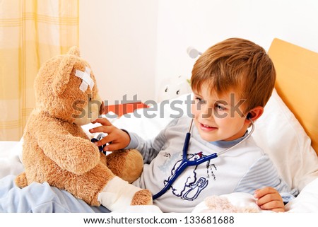 a sick child examined teddy with stethoscope