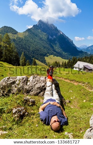 a hiker is recovering from a hike in the mountains of austria. activity during leisure time