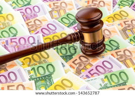 judges gavel and euro banknotes. symbol photo for costs in court of law and auctions