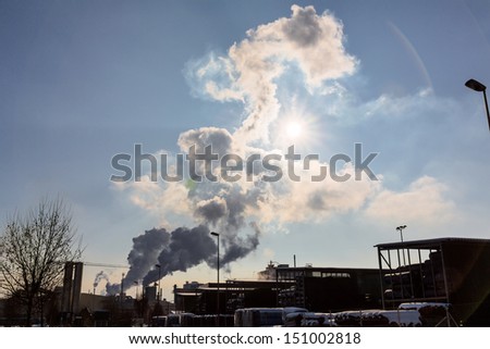 an industrial plant chimney with smoke. symbolic photo for environmental protection and ozone.