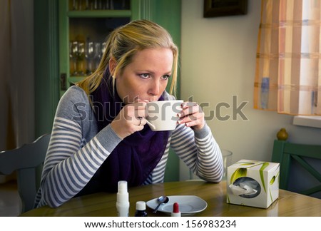 woman on sick leave with tea and medicines. cold, cold and flu season
