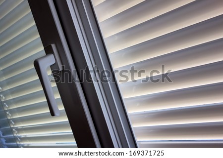 to protect against heat and sun blinds are attached to a window.