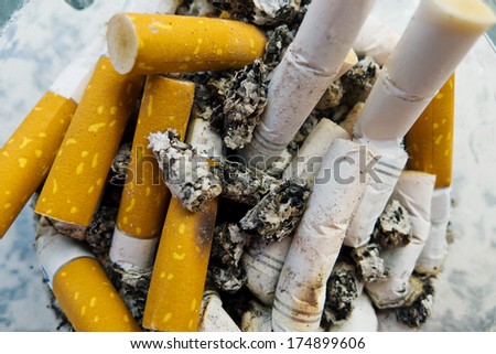 cigarette butts in an ashtray, symbol photo for chain smoking and health risk