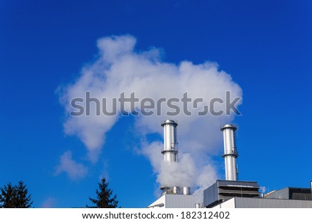 chimney of an industrial company a wake smoke. symbolic photo for environmental protection and ozone.
