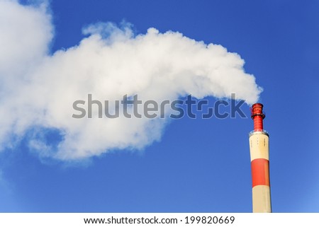 chimney of an industrial company with smoke. symbolic photo for environmental protection and ozone.