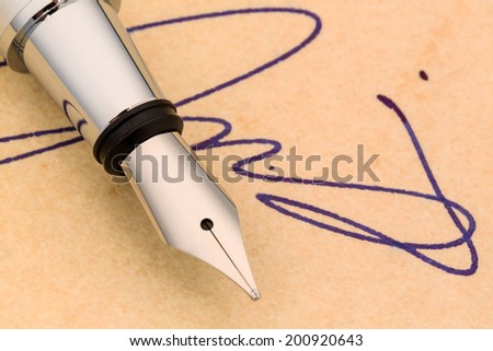 a signature and a fountain pen on yellow paper. symbolic photo for contract testament and graphology
