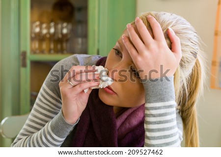 woman on sick leave with handkerchief. symbolic photo for colds, flu and flu season