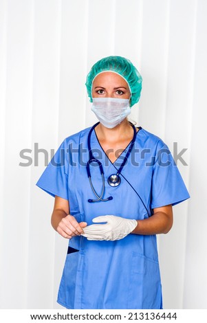 a nurse or doctor in surgical clothes before surgery. symbol photo for work in the hospital.