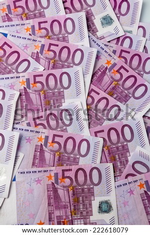 many of five hundred euro banknotes lie side by side. symbol photo for wealth and investment