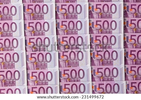 many of five hundred euro banknotes lie side by side. photo icon for wealth and investment