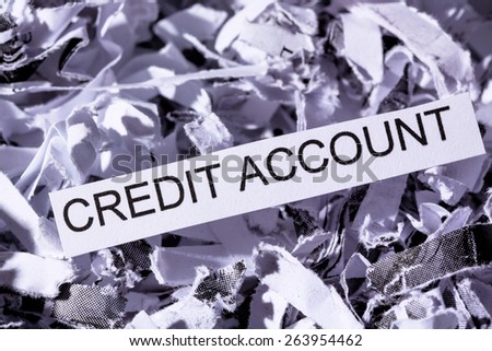 shredded paper tagged with credit account, symbolic photo for data destruction, financing and credit