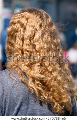 woman with long blond hair, a symbol of femininity, anonymity
