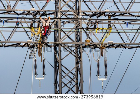 construction of a new high-voltage line. workers on electricity pylons