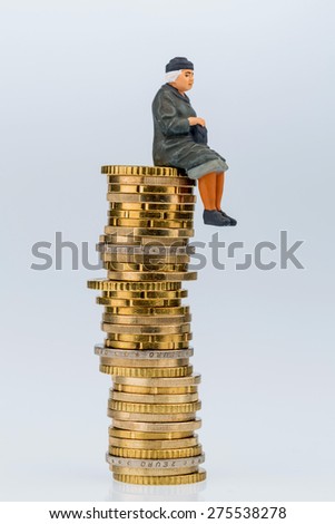 pensioner sitting on money stack, symbol photo for retirement, pension, old-age insurance