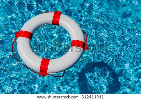 an emergency tire floating in a pool. symbolic photo for rescue and crisis management in the financial crisis and banking crisis.