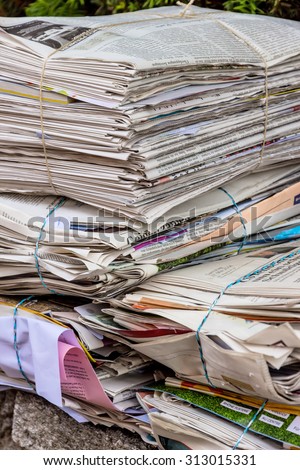 a stack of old newspapers ready for removal by waste paper disposal