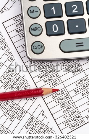 a calculator is located on the numbers a balance us statistics. photo icon for sales, profit and cost.