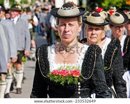 BAD TOELZ, GERMANY - JULY 1 - Women at the Corpus Christi procession at July 1, 2012 in Bad Toelz - Germany. The women walk over the Isar bridge and wear traditional costumes.