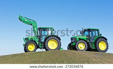 MUNICH, GERMANY - FEBRUARY 29 - A John Deere Model 6630 and 6430 - new tractors at a field at February 29, 2012 near munich - germany