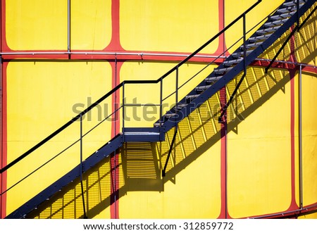 yellow modern storage tanks in front of blue sky