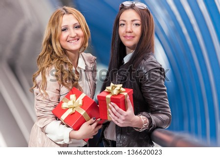two girls with gifts/ two girls holding gift in hands