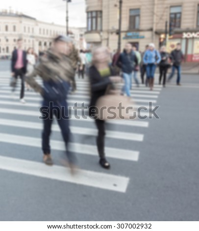 people walking on crosswalk with blur city background, blur motion