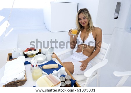 young woman enjoying her breakfast in hotel room.