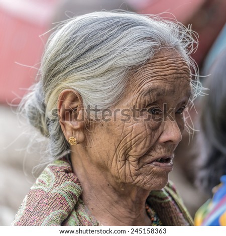 Lokomata, Sulawesi, Indonesia - September 9, 2014: Portrait of a senior woman of Toraja ethnicity with fun facial expression, in Lokomata, Tana Toraja, Sulawesi, Indonesia.