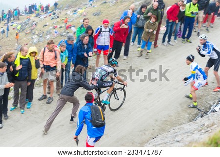 Meana di Susa, Italy - May 30, 2015: Supporter helping a cyclist to climb \
