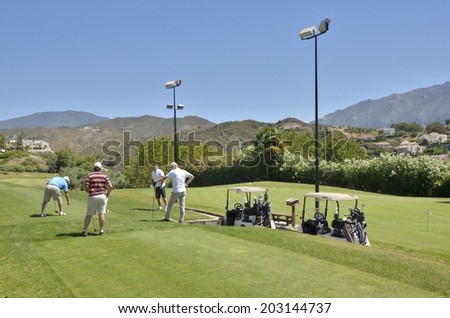 MARBELLA, SPAIN - MAY 30: Golf players on May 30, 2014 at La Quinta golf,  in Marbella, Spain. Gof players prepared to strike at the tee.