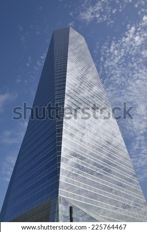 MADRID, SPAIN - OCTOBER, 18: Clouds reflected in the Crystal Tower in the Four Towers Business Area, on October 18, 2014 in Madrid, Spain.   The Crystal tower was designed by Pelli.