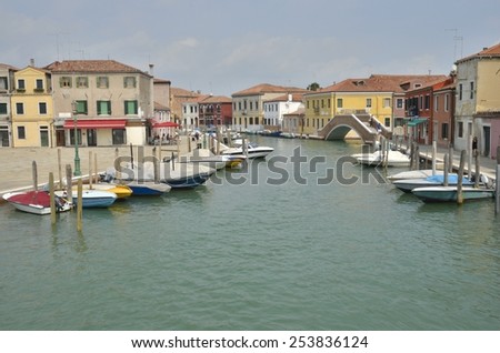 MURANO, ITALY -AUGUST 10: Beautiful canal with boats parked along the canal on August 10, 2014 in Murano, an island of Venice, Italy