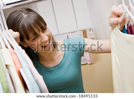 Curious teenager searching in closet for something to wear