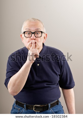Man covering mouth gesturing for silence