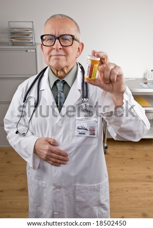 Doctor in lab coat and stethoscope holding prescription medication bottle