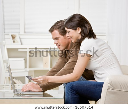 Couple using credit card to shop online conveniently