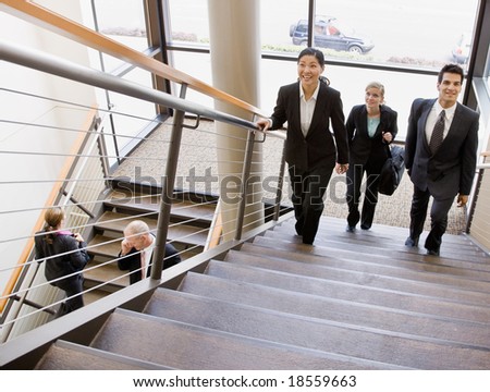 Multi-ethnic co-workers ascending office stairs
