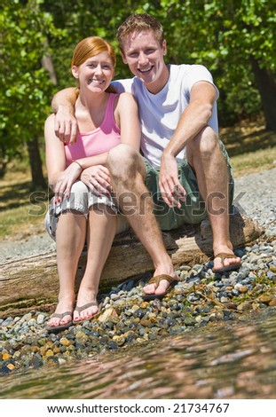 Couple sitting near stream