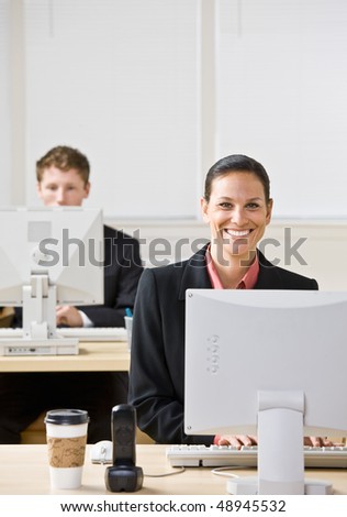 Business people typing on computers