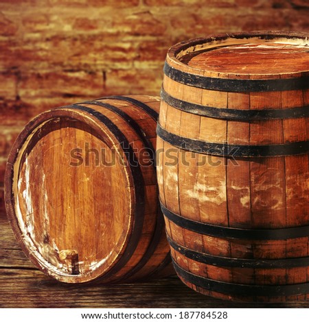 Old oak barrels on the brick wall backgroung.